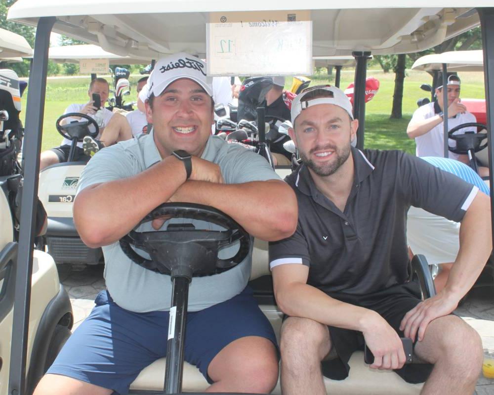 2 men in a golf cart
